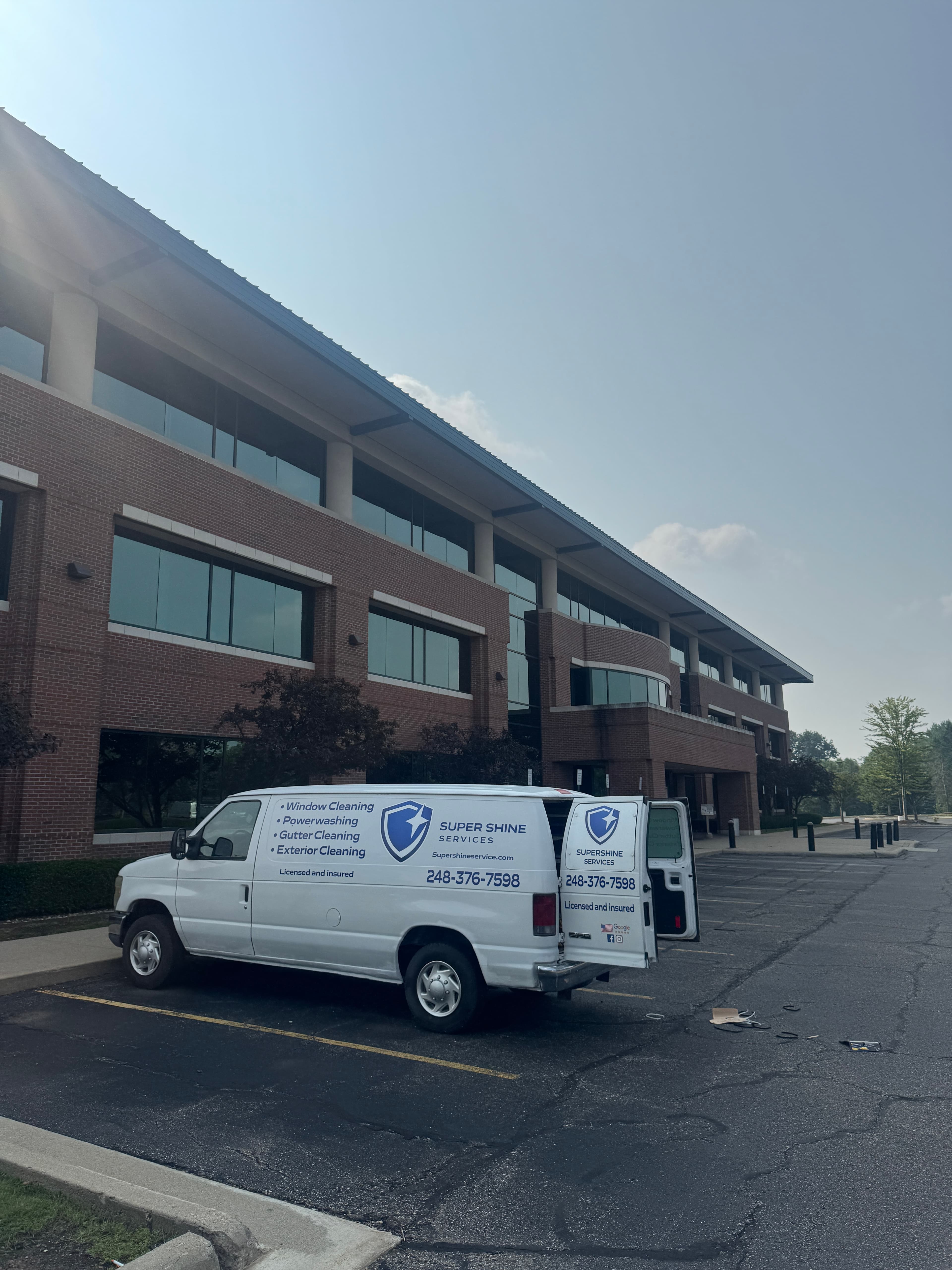 Super Shine Services branded truck parked outside a commercial office building