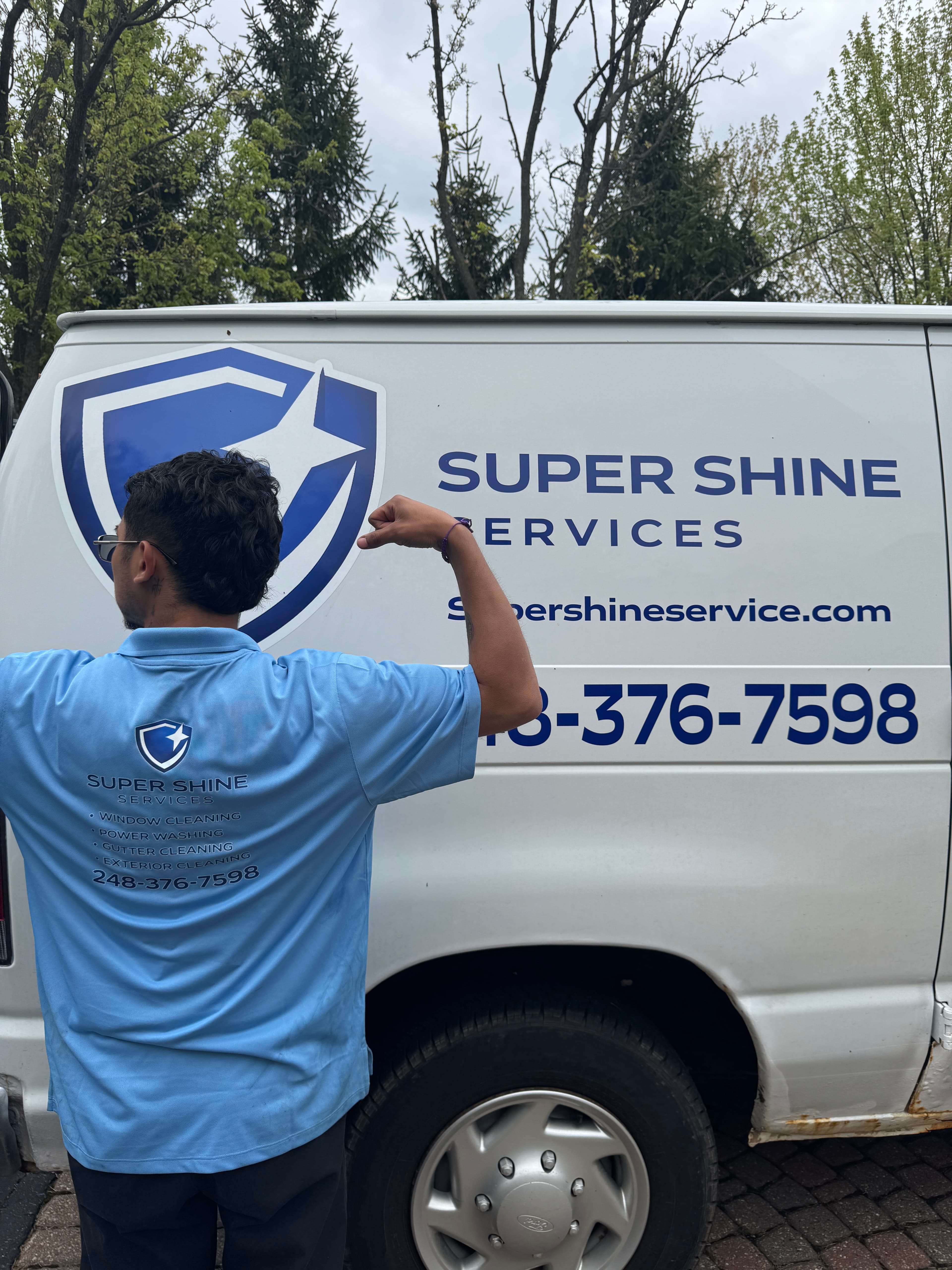 Super Shine Services team member with the branded work truck showing the full service list